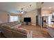 Open-concept living area with wood floors, TV, and seamless transition to the kitchen at 12840 Sw 60Th Ct, Ocala, FL 34473