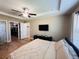 Spacious bedroom featuring a tray ceiling, ceiling fan, and large walk-in closet at 12840 Sw 60Th Ct, Ocala, FL 34473