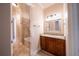 Hallway view of a bathroom featuring a vanity with granite counters, dark cabinets, a mirror, and tub at 1450 Se 73Rd Pl, Ocala, FL 34480