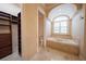 Luxurious bathroom featuring a soaking tub, closet, and separate toilet area at 1450 Se 73Rd Pl, Ocala, FL 34480