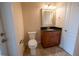 Well-lit bathroom featuring a vanity with granite countertop and neutral tile flooring at 1450 Se 73Rd Pl, Ocala, FL 34480