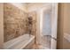 A bathtub with tile surround features a detachable shower head; doorway to another room visible at 1450 Se 73Rd Pl, Ocala, FL 34480