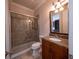 Bathroom showcasing a glass-enclosed shower, toilet, and granite vanity with dark wood cabinets at 1450 Se 73Rd Pl, Ocala, FL 34480