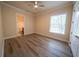 Bedroom featuring wood-look floors, ceiling fan, and ensuite bathroom at 1450 Se 73Rd Pl, Ocala, FL 34480