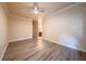 Neutral bedroom featuring laminate flooring, ceiling fan, and entry to private bathroom at 1450 Se 73Rd Pl, Ocala, FL 34480