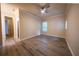 Bedroom with wood-look flooring, ceiling fan, and natural light streaming in from the window at 1450 Se 73Rd Pl, Ocala, FL 34480