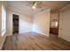 Bedroom featuring wood-look floors and offering access to a walk-in closet and bathroom at 1450 Se 73Rd Pl, Ocala, FL 34480