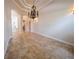 Open dining area featuring large archways, neutral walls, tiled floors, and a decorative chandelier at 1450 Se 73Rd Pl, Ocala, FL 34480