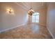 Bright dining room featuring a large window, chandelier, and decorative wall sconces at 1450 Se 73Rd Pl, Ocala, FL 34480