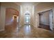 Inviting foyer with tile flooring, chandelier, and view into the front door and other living spaces at 1450 Se 73Rd Pl, Ocala, FL 34480
