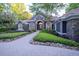 Charming home featuring stone accents, arched windows, and a beautifully landscaped front yard at 1450 Se 73Rd Pl, Ocala, FL 34480