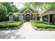 Charming home featuring stone accents, arched windows, and a beautifully landscaped front yard at 1450 Se 73Rd Pl, Ocala, FL 34480