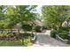 Beautiful front exterior with lush landscaping, brick driveway, and a well-maintained lawn, enhancing curb appeal at 1450 Se 73Rd Pl, Ocala, FL 34480