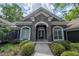 Stunning front exterior of the house with stone siding, arched windows and manicured landscaping at 1450 Se 73Rd Pl, Ocala, FL 34480