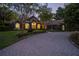 Charming home featuring stone accents, arched windows, and a paved driveway at 1450 Se 73Rd Pl, Ocala, FL 34480