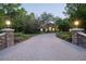 Well-maintained home featuring stone accents, arched windows, and a long paved driveway at 1450 Se 73Rd Pl, Ocala, FL 34480
