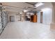 Bright garage with tiled floor, storage cabinets, shelving, and two large closet spaces at 1450 Se 73Rd Pl, Ocala, FL 34480
