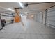 Large garage featuring tile floors, ample lighting, and plenty of space for storage at 1450 Se 73Rd Pl, Ocala, FL 34480
