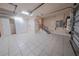Well-lit garage featuring tiled floor, storage closets, and stair access to an upper level at 1450 Se 73Rd Pl, Ocala, FL 34480