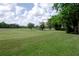 Scenic view of a well-maintained golf course with lush green fairways and trees at 1450 Se 73Rd Pl, Ocala, FL 34480