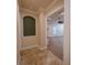 Hallway leading to a room with tray ceilings, ceiling fan, and natural light streaming through the window at 1450 Se 73Rd Pl, Ocala, FL 34480