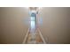 Long hallway with tile flooring leading to bright, open living space at 1450 Se 73Rd Pl, Ocala, FL 34480