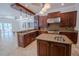 Kitchen featuring granite countertops, island with sink, stainless steel appliances, and custom cabinetry at 1450 Se 73Rd Pl, Ocala, FL 34480