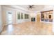 Open-concept living room with fireplace, built-in shelving, and access to the kitchen at 1450 Se 73Rd Pl, Ocala, FL 34480