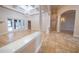 Elegant living room with coffered ceilings, a crystal chandelier, and marble-look tile flooring at 1450 Se 73Rd Pl, Ocala, FL 34480