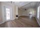 Expansive living room with a fireplace, hardwood floors, and access to the lanai at 1450 Se 73Rd Pl, Ocala, FL 34480