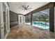 The covered patio space overlooking the pool and outdoor kitchen provide multiple options for outdoor entertainment at 1450 Se 73Rd Pl, Ocala, FL 34480