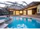 Beautiful pool and spa with screened enclosure and outdoor kitchen are perfect for relaxation and outdoor living at 1450 Se 73Rd Pl, Ocala, FL 34480