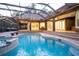 An inviting pool and spa with screened enclosure and outdoor kitchen area, perfect for entertaining and relaxation at 1450 Se 73Rd Pl, Ocala, FL 34480