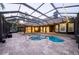 This screened-in pool area and outdoor kitchen offer the perfect space for entertaining and enjoying outdoor living at 1450 Se 73Rd Pl, Ocala, FL 34480