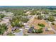 An aerial view of a community with houses surrounded by wooded areas and vacant lots at 14978 Sw 46Th Cir, Ocala, FL 34473
