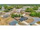 Expansive aerial view of a single-Gathering home in a quiet neighborhood with mature trees and well-maintained lawns at 14978 Sw 46Th Cir, Ocala, FL 34473