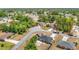 Aerial view showing a home in a residential area with surrounding mature trees and a construction site in the distance at 14978 Sw 46Th Cir, Ocala, FL 34473