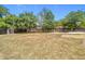 Large backyard featuring mature trees and a play area, providing ample space for outdoor activities at 14978 Sw 46Th Cir, Ocala, FL 34473
