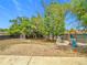 Large, fenced backyard with playground equipment, mature trees, and ample space for outdoor activities at 14978 Sw 46Th Cir, Ocala, FL 34473