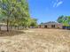 Spacious backyard with a partially fenced perimeter, mature trees, and room for outdoor enjoyment at 14978 Sw 46Th Cir, Ocala, FL 34473