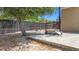 Fenced backyard area featuring a basketball hoop, mature trees, and a concrete slab for outdoor activities at 14978 Sw 46Th Cir, Ocala, FL 34473