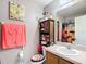 Stylish bathroom featuring a vanity, decorative shelving, and a charming accent mirror at 14978 Sw 46Th Cir, Ocala, FL 34473