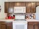 Close up on kitchen featuring dark cabinetry, stainless steel appliances, and tiled backsplash at 14978 Sw 46Th Cir, Ocala, FL 34473