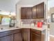 Kitchen sink featuring dark cabinetry and neutral countertops at 14978 Sw 46Th Cir, Ocala, FL 34473