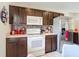 Close up on kitchen featuring dark cabinetry, stainless steel appliances, and tiled backsplash at 14978 Sw 46Th Cir, Ocala, FL 34473