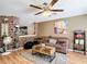 Cozy living room featuring a decorative brick wall, comfortable seating, stylish decor, and wood floors at 14978 Sw 46Th Cir, Ocala, FL 34473