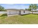 This backyard has a patio, grassy lawn, and a fence surrounding the property at 15044 Sw 35Th Avenue Rd, Ocala, FL 34473