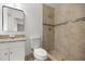 Updated bathroom featuring a tiled shower, new vanity, and granite countertop at 15044 Sw 35Th Avenue Rd, Ocala, FL 34473