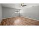 Bedroom featuring hardwood floors, ceiling fan, and a window that brings in plenty of light at 15044 Sw 35Th Avenue Rd, Ocala, FL 34473