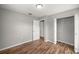 Bedroom featuring hardwood floors, closet, and views into other rooms at 15044 Sw 35Th Avenue Rd, Ocala, FL 34473